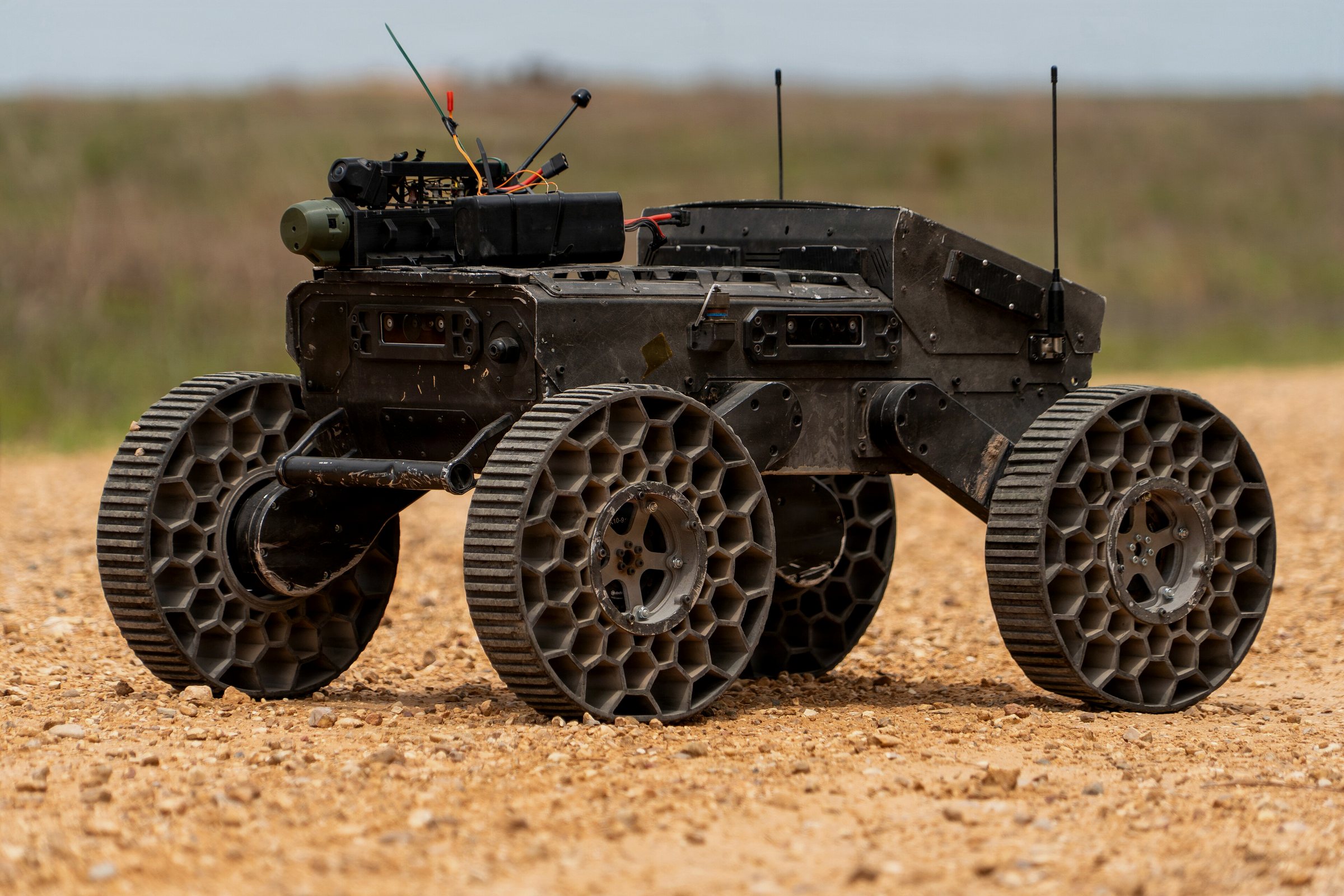 Uncrewed ground vehicle on open terrain, a representative host platform for PERSEUS